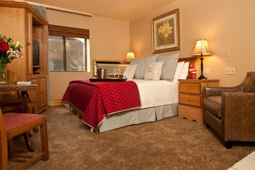 a bedroom with a bed with a red blanket at Inn on The Creek in Jackson
