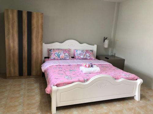 a bedroom with a bed with a stuffed animal on it at Pani House Hatyai 1 in Hat Yai
