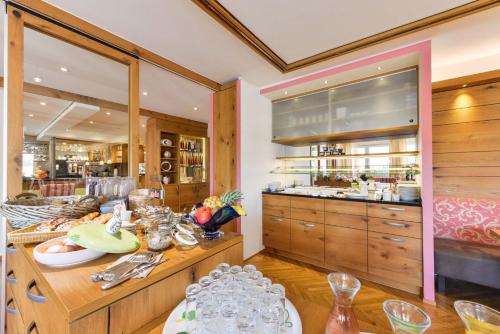 a kitchen with wooden cabinets and a counter with dishes at Jauch's Löwen Hotel-Restaurant in Neuershausen