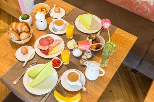 a table with breakfast foods and coffee on it at Jauch's Löwen Hotel-Restaurant in Neuershausen