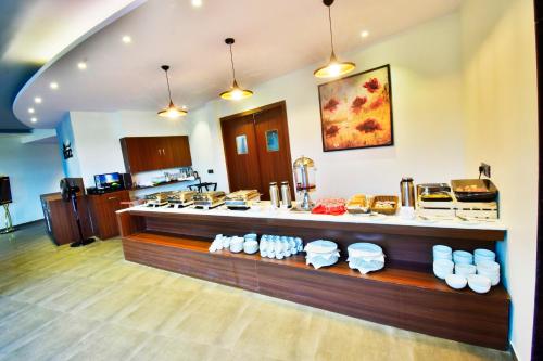 a kitchen with a counter with food on it at Aura One Hotel in Cochin