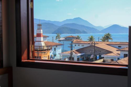 a view from a window of a lighthouse at Pousada Don Diego in Ubatuba
