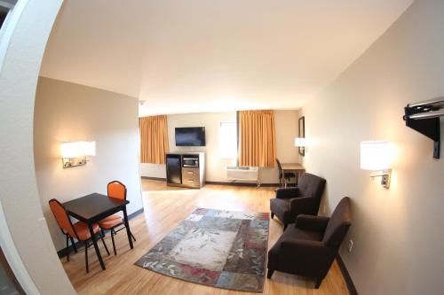 a living room with a couch and chairs and a table at Super 8 by Wyndham Portsmouth in Portsmouth