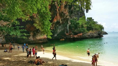 a group of people on a beach in the water at Anawin Bungalows in Ao Nang Beach