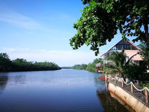 a river with a building on the side of it at Homestay ALA Riverview Lodge Kota Bharu in Kota Bharu