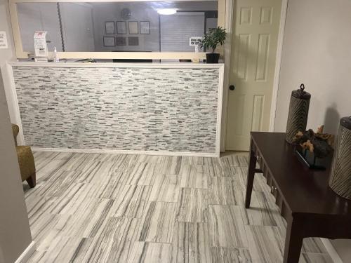 a kitchen with a counter and a wooden floor at Enterprise Motel in Kissimmee