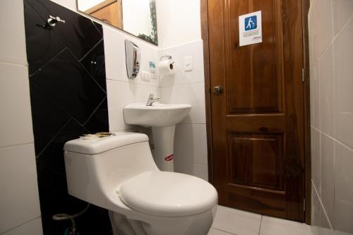 a bathroom with a toilet and a sink at Hostal Alpachaca - New Quito Airport in Tababela