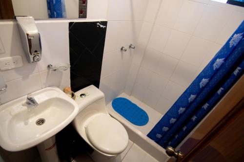 a bathroom with a sink and a toilet and a shower at Hostal Alpachaca - New Quito Airport in Tababela