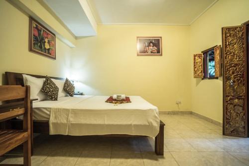 Postel nebo postele na pokoji v ubytování Tegar Guest House Ubud