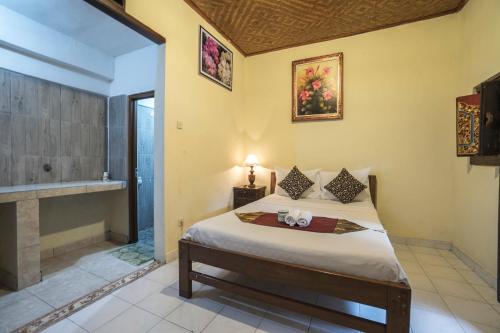 Postel nebo postele na pokoji v ubytování Tegar Guest House Ubud