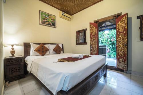 Postel nebo postele na pokoji v ubytování Tegar Guest House Ubud