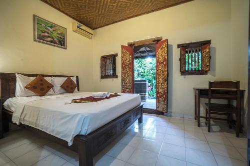 Postel nebo postele na pokoji v ubytování Tegar Guest House Ubud