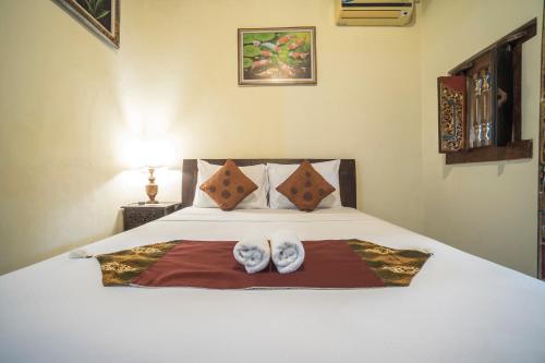 Postel nebo postele na pokoji v ubytování Tegar Guest House Ubud
