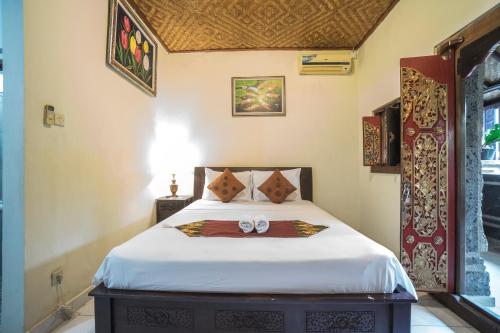 Postel nebo postele na pokoji v ubytování Tegar Guest House Ubud