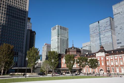 a building in a city with tall buildings at Hotel Metropolitan Tokyo Marunouchi in Tokyo