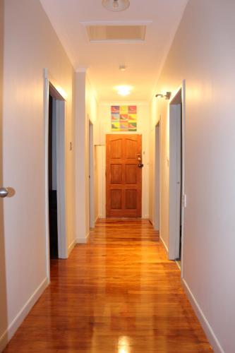 a hallway of a house with a wooden door at Mini Homestay in Auckland