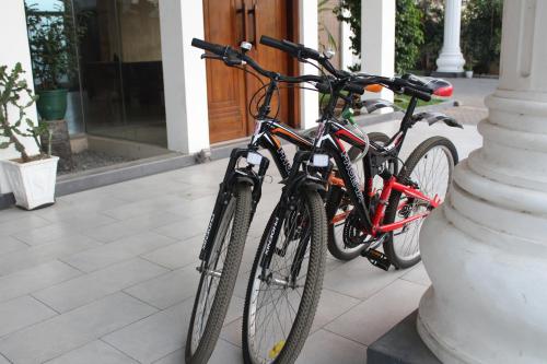 two bikes parked next to each other on a sidewalk at The Valampuri in Jaffna