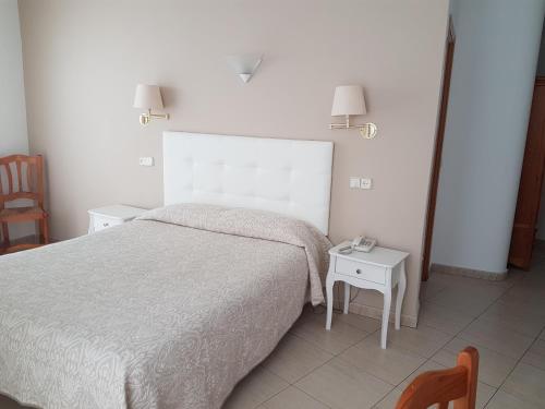 Postel nebo postele na pokoji v ubytování Hostal Centro
