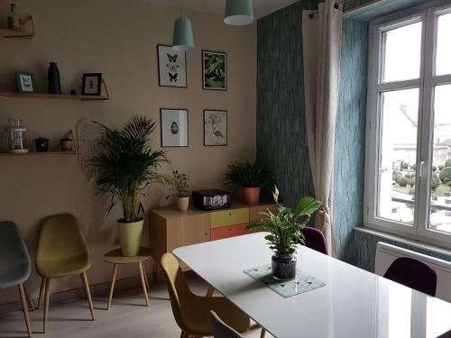 a dining room with a table and chairs and a window at Le Prestige Saint André in Châteauroux
