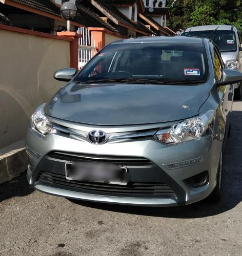 a silver car parked in a parking lot at Seri Lagenda Apartment in Kuah