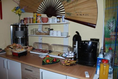 a kitchen with a counter with food on it at Hotel Alte Post in Bad Sooden-Allendorf