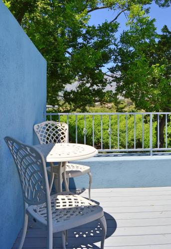 a table and two chairs and a table and a table and chairs on a patio at 1AA Wilhelmina Luxury Suites in Franschhoek