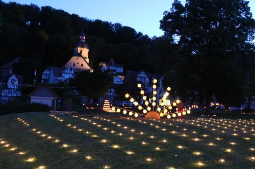 a large yard with lights in front of a house at Hotel Alte Post in Bad Sooden-Allendorf