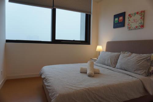 a bedroom with a bed with a stuffed animal on it at THE HUB SS2 in Petaling Jaya