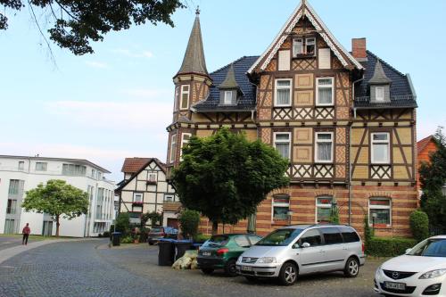 an old building with cars parked in front of it at Hotel Alte Post in Bad Sooden-Allendorf