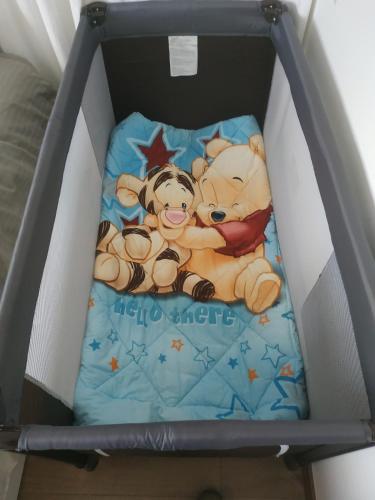 two teddy bears laying on a bed in a box at City Center Apartments in Paphos City