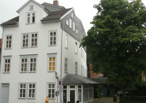 科堡的住宿－Apartment Leopold mit Balkon，前面有一棵树的白色房子