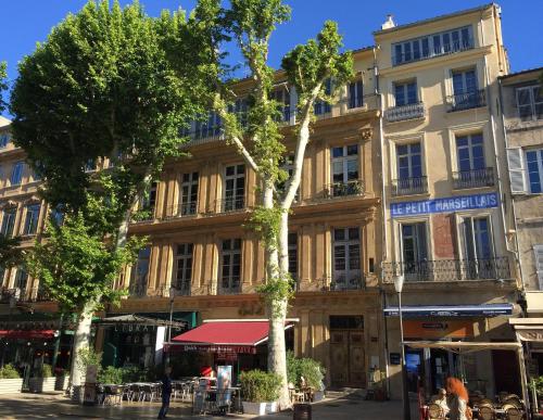 a building with a tree in front of it at Les Suites du Cours & Spa in Aix-en-Provence