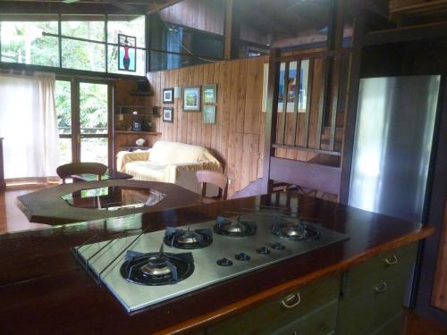 a kitchen with a stove top in a room at Daintree Holiday Homes - The Folly in Diwan