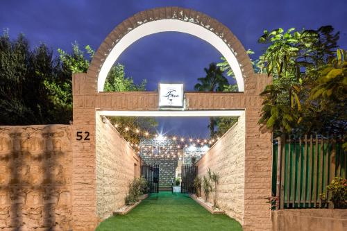 an archway with a view of the city behind it at Hotel La Finca - Luxury Suites Hotel in Beer Sheva