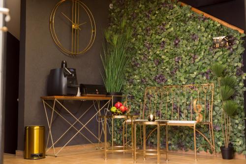 a living room with a wall covered in plants at Hotel La Finca - Luxury Suites Hotel in Beer Sheva