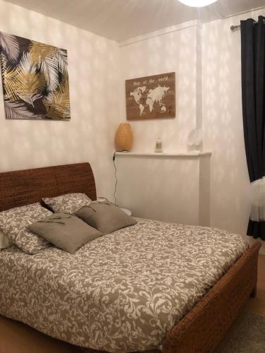 a bedroom with a bed and a painting on the wall at la Salaberie in Villeréal