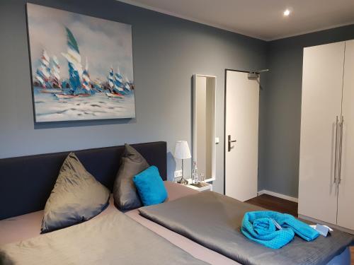 een slaapkamer met een bed met een blauwe deken erop bij Hotel Nacht-Quartier in Willich