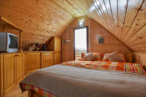 a bedroom with a bed in a wooden cabin at Lumber Apartments Kolašin in Kolašin