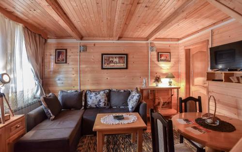 a living room with a couch and a table at Lumber Apartments Kolašin in Kolašin