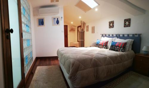 a bedroom with a large bed in a room at Alojamento Local Ferros - Duplex in Viana do Castelo