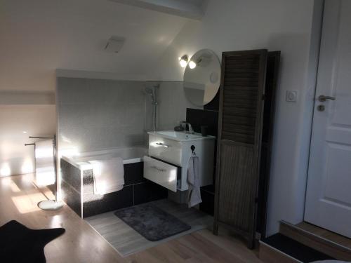 a bathroom with a sink and a mirror at Au lévrier de chessy in Chessy