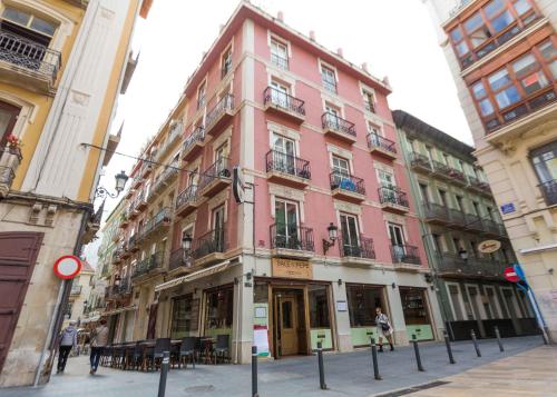 a pink building on the corner of a street at Loft Pasarela in Alicante
