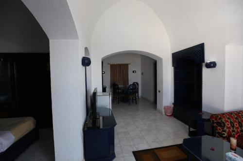 a living room with a couch and a tv at New Panorama Resort in Fayoum Center