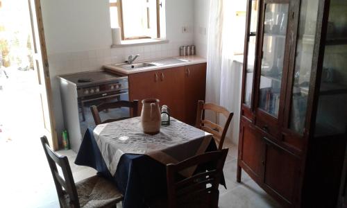 a kitchen with a table with a vase on it at Christiana's stone studios in Pano Lefkara