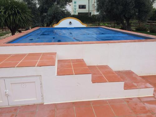 an overhead view of a swimming pool with a tile floor at Quinta Ribeira do Labrador - Lisbon West Wine Route in Alenquer