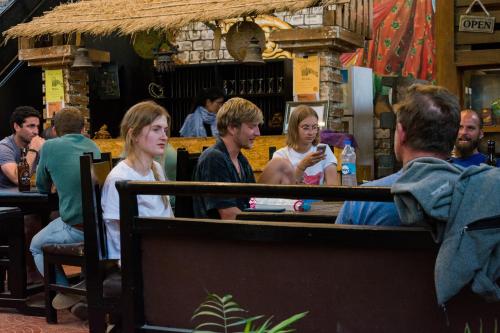 a group of people sitting at a bar at Wander Thirst in Kathmandu