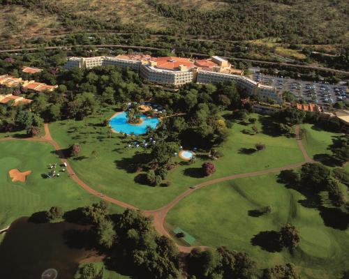 a park filled with lots of green grass and trees at Soho Hotel & Casino at Sun City in Sun City