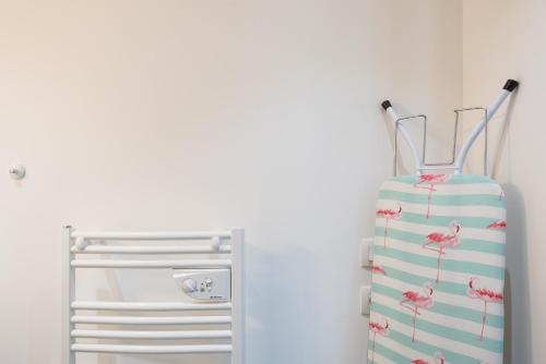 a small refrigerator with a pink flamingo towel at Appart République parking privé gratuit in Lille