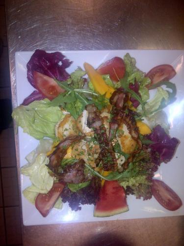 a plate of food with a salad on a table at Apart Rustica in Kaunertal