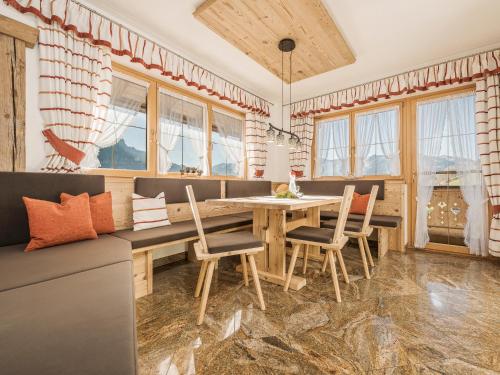 a dining room with a wooden table and chairs at Hanserhof in Zell am Ziller